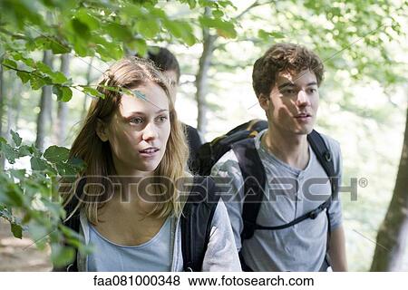 Stock Photo - Friends hiking in woods. Fotosearch