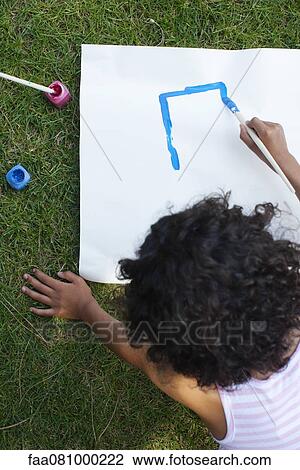 Stock Image - Girl drawing on white paper, directly above. Fotosearch