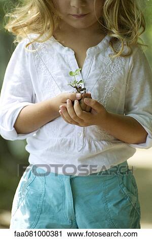 Stock Image - Girl holding seedling. Fotosearch