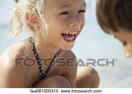 Stock Photography - Girl laughing outdoors. Fotosearch