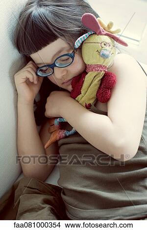 Girl napping with stuffed toy View Large Photo Image Picture - Girl napping with stuffed toy. Fotosearch