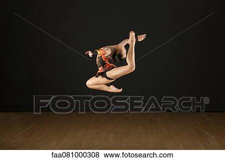 Stock Photo - Gymnast jumping in air. Fotosearch