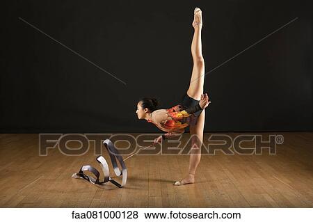 Gymnast performing standing splits View Large Photo Image Stock Photo - Gymnast performing standing splits. Fotosearch