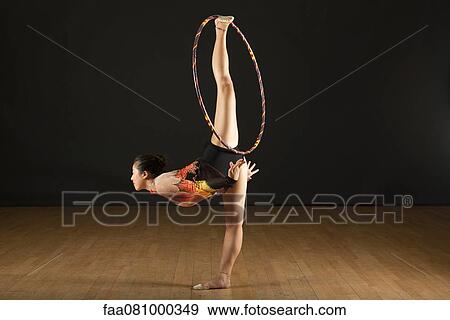 Gymnast performing standing splits with hood View Large Photo Image Stock Photo - Gymnast performing standing splits with hood. Fotosearch