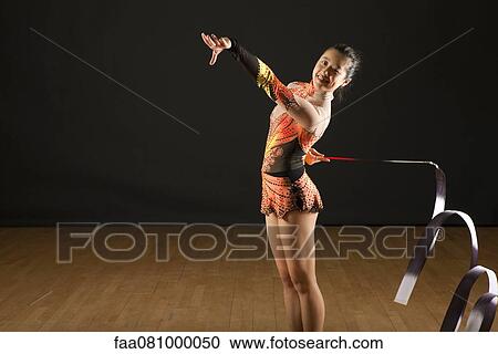 Stock Image - Gymnast twirling ribbon. Fotosearch