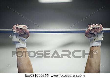 Stock Photography - Gymnast's arms gripping horizontal bar, cropped. Fotosearch