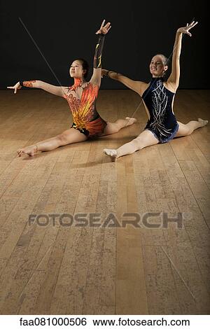 Gymnasts performing splits together View Large Photo Image Stock Photograph - Gymnasts performing splits together. Fotosearch