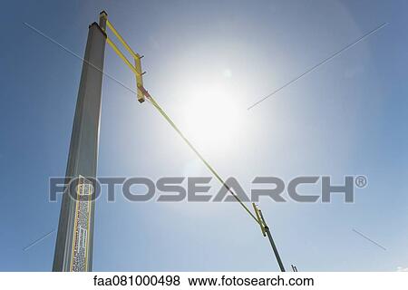 Stock Photo - High jump bar, low angle view, backlit. Fotosearch