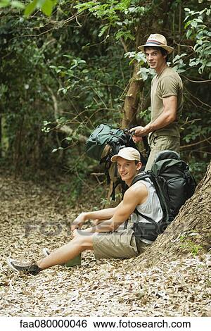 Stock Photograph - Hikers taking a break in woods. Fotosearch