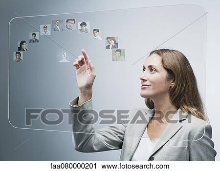 Human resources manager assessing candidates on advanced touch screen interface View Large Photo Image Stock Image - Human resources manager assessing candidates on advanced touch screen interface. Fotosearch