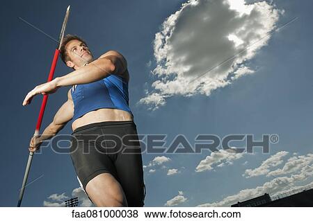 Javelin thrower aiming, low angle view View Large Photo Image Stock Photo - Javelin thrower aiming, low angle view. Fotosearch