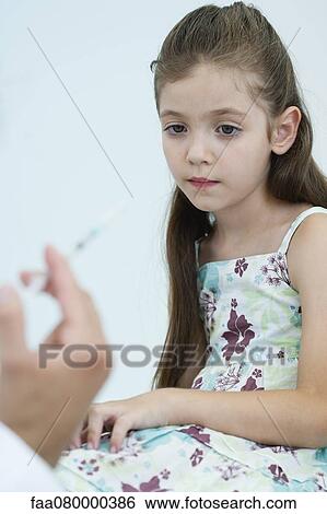 Little girl anxiously awaiting vaccination View Large Photo Image Stock Photograph - Little girl anxiously awaiting vaccination. Fotosearch