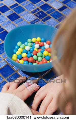 Little girl contemplating bowl of candy View Large Photo Image Stock Image - Little girl contemplating bowl of candy. Fotosearch