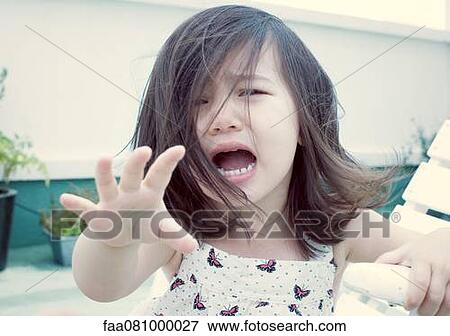 Stock Photo - Little girl crying, portrait. Fotosearch