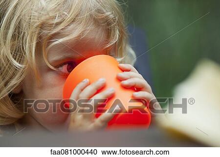 Stock Image - Little girl drinking from cup. Fotosearch