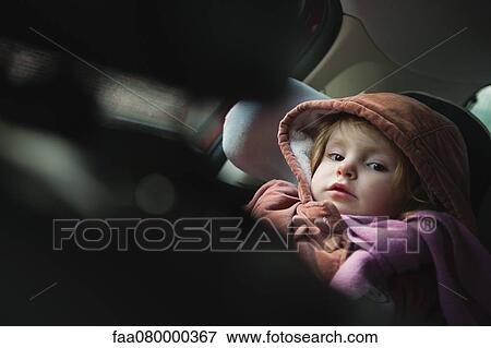Stock Photo - Little girl in car seat, portrait. Fotosearch