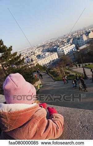 Stock Photography - Little girl looking at view of city, Montmartre, Paris, France. Fotosearch