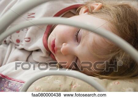 Stock Photo - Little girl napping, close-up. Fotosearch