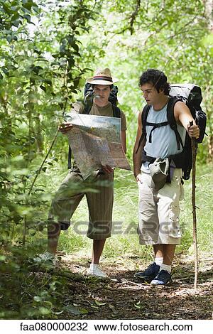 Stock Image - Lost hikers reading map. Fotosearch