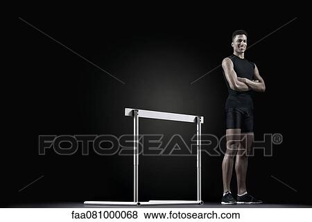 Male athlete standing by hurdle, portrait View Large Photo Image Stock Photo - Male athlete standing by hurdle, portrait. Fotosearch