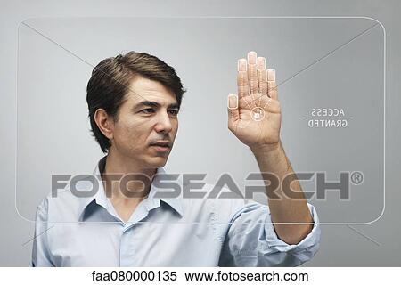 Stock Photography - Man gaining access on touch screen interface using biometrics system. Fotosearch