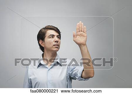Man using large transparent touch screen to authenticate his handprint View Large Photo Image Stock Image - Man using large transparent touch screen to authenticate his handprint. Fotosearch
