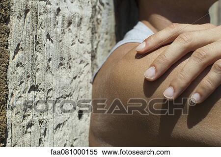 Stock Photography - Man's hand on bare shoulder. Fotosearch