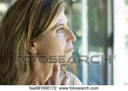 Mature woman looking away in thought View Large Photo Image Stock Image - Mature woman looking away in thought. Fotosearch