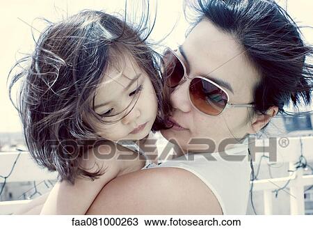 Stock Image - Mother comforting little girl outdoors. Fotosearch