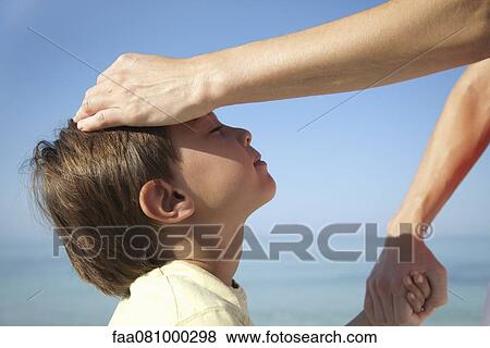 Mother's hand on boy's head View Large Photo Image Stock Photo - Mother's hand on boy's head. Fotosearch