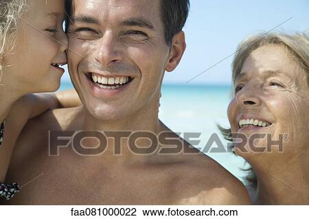 Stock Image - Multi-generation family at the beach, portrait. Fotosearch