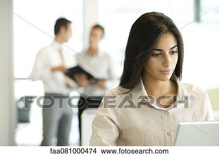 Picture - Professional woman working in office. Fotosearch