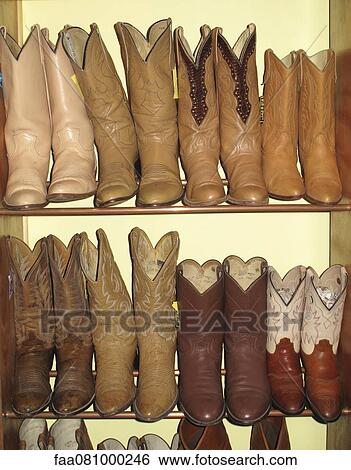 Rack of cowboy boots in thrift store View Large Photo Image Stock Photograph - Rack of cowboy boots in thrift store. Fotosearch