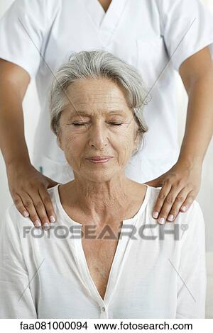 Senior woman getting a massage, cropped View Large Photo Image Picture - Senior woman getting a massage, cropped. Fotosearch