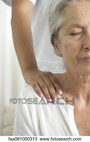 Senior woman getting a shoulder massage, cropped View Large Photo Image Stock Image - Senior woman getting a shoulder massage, cropped. Fotosearch