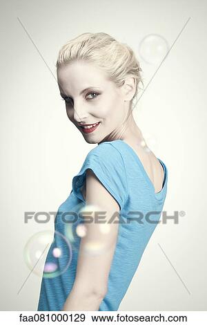 Stock Photo - Smiling young woman, portrait. Fotosearch