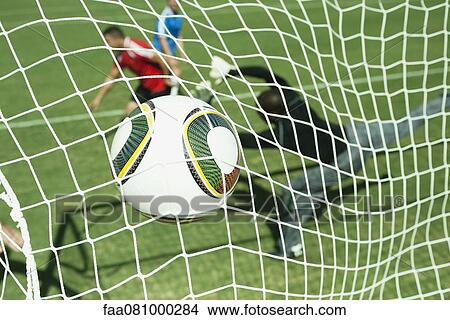 Picture - Soccer ball hitting goal net. Fotosearch