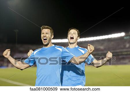 Stock Photo - Soccer players celebrating, portrait. Fotosearch