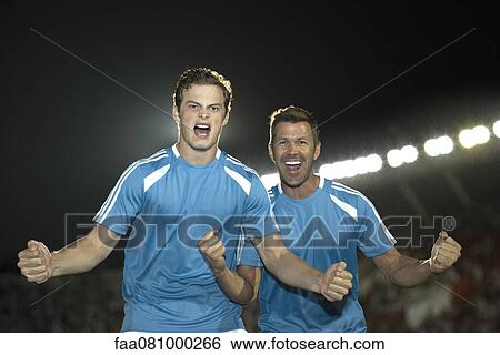 Stock Photograph - Soccer players cheering, portrait. Fotosearch
