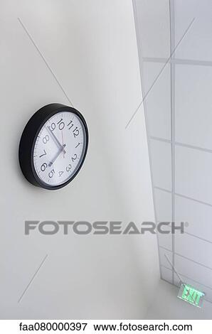 Wall clock and exit sign in office View Large Photo Image Stock Photo - Wall clock and exit sign in office. Fotosearch