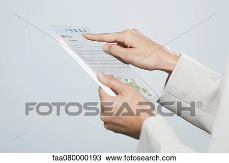 Woman checking email using futuristic digital tablet, cropped View Large Photo Image Stock Image - Woman checking email using futuristic digital tablet, cropped. Fotosearch