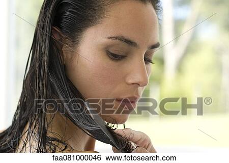 Stock Photograph - Woman combing wet hair. Fotosearch