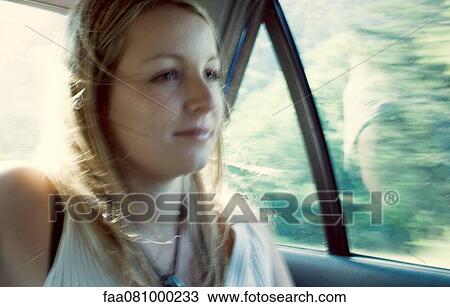 Woman riding in car, defocused View Large Photo Image Stock Image - Woman riding in car, defocused. Fotosearch