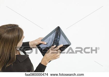 Woman using digital tablet, overhead view View Large Photo Image Picture - Woman using digital tablet, overhead view. Fotosearch