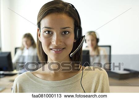 Woman using headset in office, portrait View Large Photo Image Stock Image - Woman using headset in office, portrait. Fotosearch