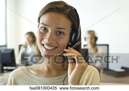 Woman using headset in office, portrait View Large Photo Image Stock Photography - Woman using headset in office, portrait. Fotosearch