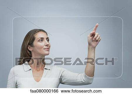 Stock Photograph - Woman using large transparent touch screen. Fotosearch