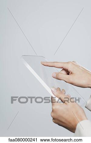 Stock Image - Woman using transparent digital tablet, cropped. Fotosearch
