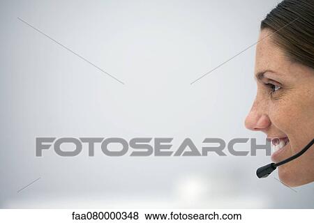Woman wearing headset, profile View Large Photo Image Stock Photo - Woman wearing headset, profile. Fotosearch
