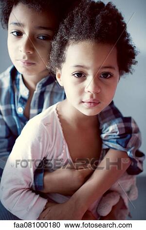 Stock Image - Young brother and sister, portrait. Fotosearch